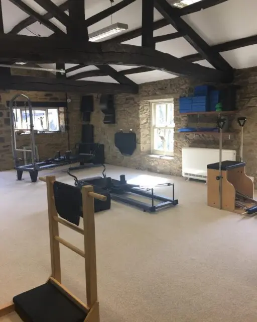 We often get asked if we do reformer classes. 

Yes we have two reformers, but no we don’t run reformer classes exclusively. 

As a Comprehensive Pilates Instructor, I teach the entire Pilates system - not just reformer classes - because Joseph Pilates designed his method as an interconnected, full-body approach using a variety of apparatus, each serving a unique purpose within the system.

The full Pilates system includes the Reformer, Cadillac, Wunda Chair, Ladder Barrel, Spine Corrector, Mat, and several smaller pieces of equipment. Each apparatus is designed to complement the others, helping the body find balance, strength, and control through a progressive and intelligently structured method. By working with the full range of equipment, I can tailor sessions precisely to each individual’s needs - whether that means supporting, challenging, or refining their movement in a way that a one-size-fits-all reformer class simply cannot.

While reformer classes can offer a great workout, they tend to be more generalised. Everyone in the room performs the same sequences, often at a similar pace, using the same springs and setup. The focus is typically on fitness rather than the therapeutic and corrective power of Pilates as a complete system.

In contrast, teaching the full system allows for a far more holistic and personalised experience. I can choose the right apparatus for each client’s body and goals on any given day - using the Cadillac to build stability, the Chair to develop power and balance, or the Barrels to restore alignment and flexibility. This way, the work meets the body where it is, rather than forcing the body to fit the work.

Ultimately, teaching the full Pilates system honours the original intention of Joseph Pilates - a complete method of movement that integrates mind, body, and spirit, and restores natural strength and vitality through precision and progression. It’s not just a class - it’s a whole-body education in movement.
